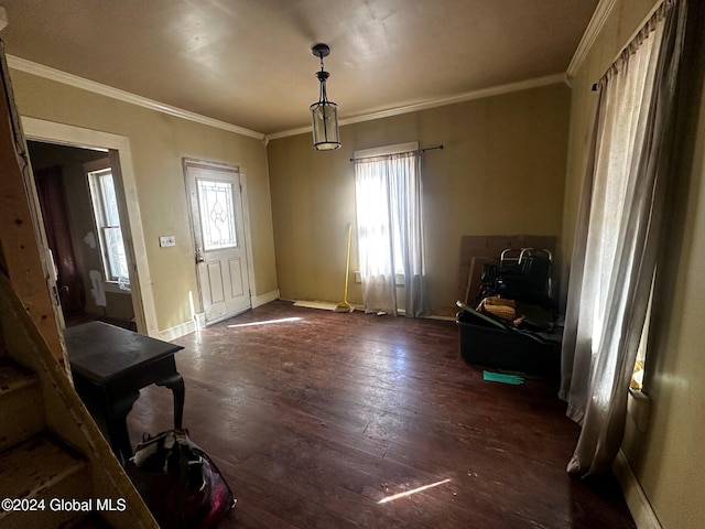 foyer entrance with dark hardwood / wood-style floors and crown molding