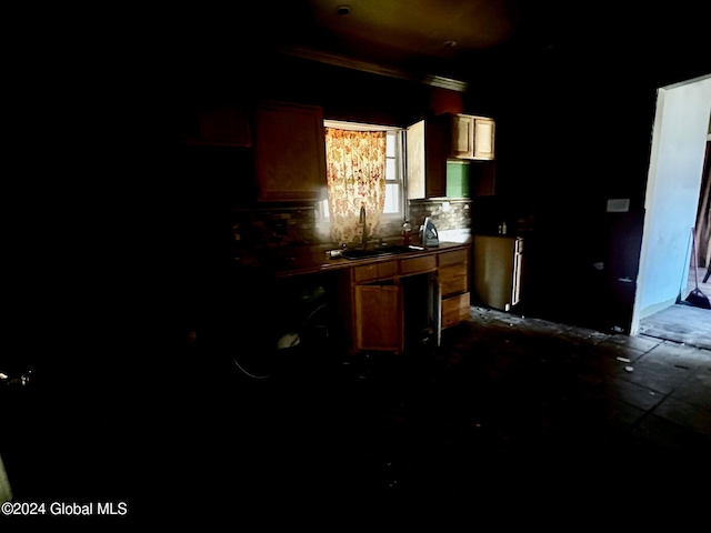 kitchen with ornamental molding, decorative backsplash, and sink