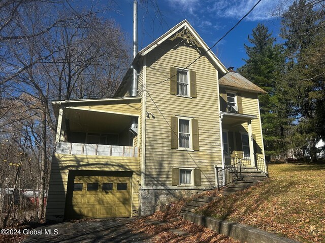 109 High St, Cobleskill, NY 12043 - view of side of property featuring an attached garage and a balcony