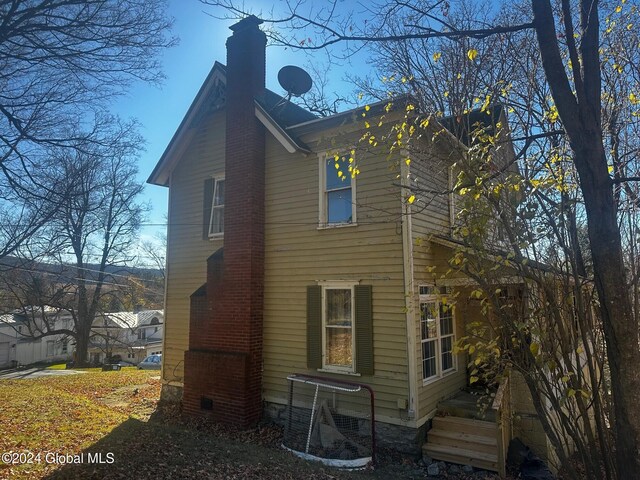 109 High St, Cobleskill, NY 12043 - view of side of property with a chimney