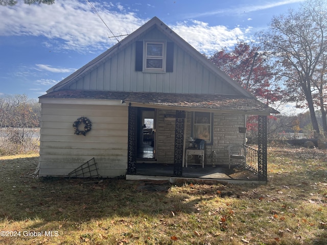 123 Iroquois Trail Rd, Amsterdam, NY 12177 - back of house with board and batten siding, a porch, and stone siding