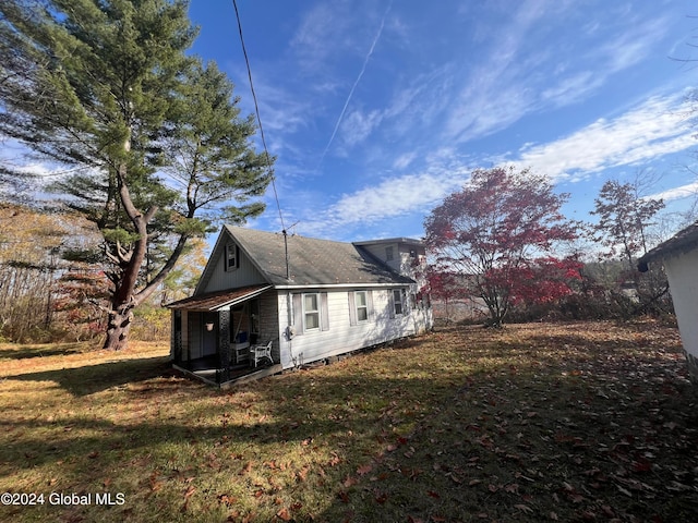 view of side of property with a lawn