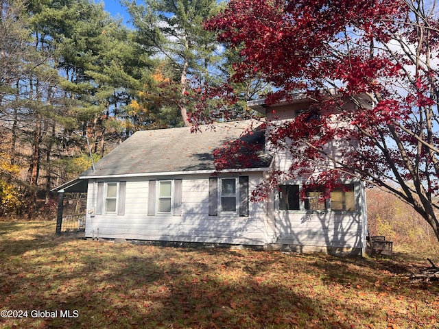 view of side of property with a lawn