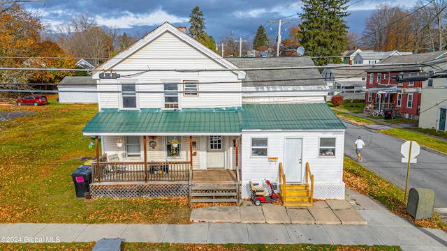 bungalow-style home featuring a porch and a front yard