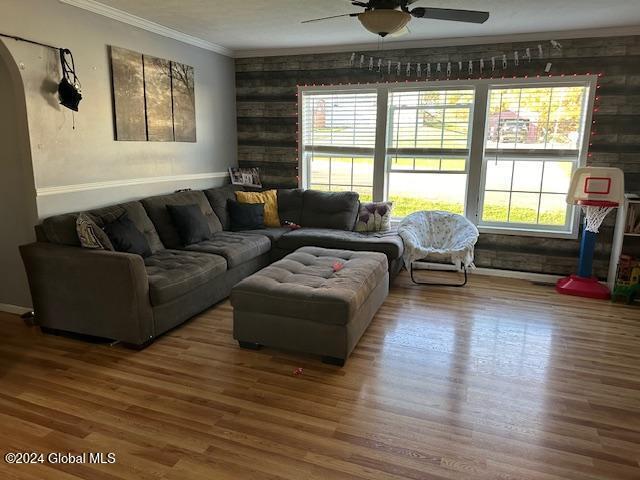 living room featuring hardwood / wood-style floors, plenty of natural light, and ceiling fan