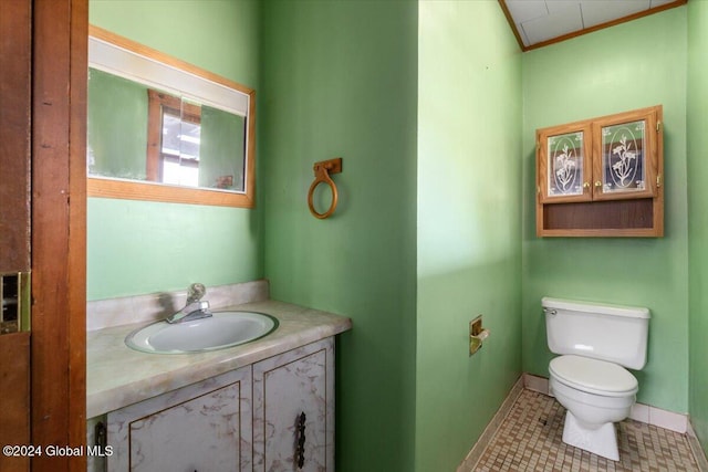 bathroom with tile patterned flooring, vanity, and toilet