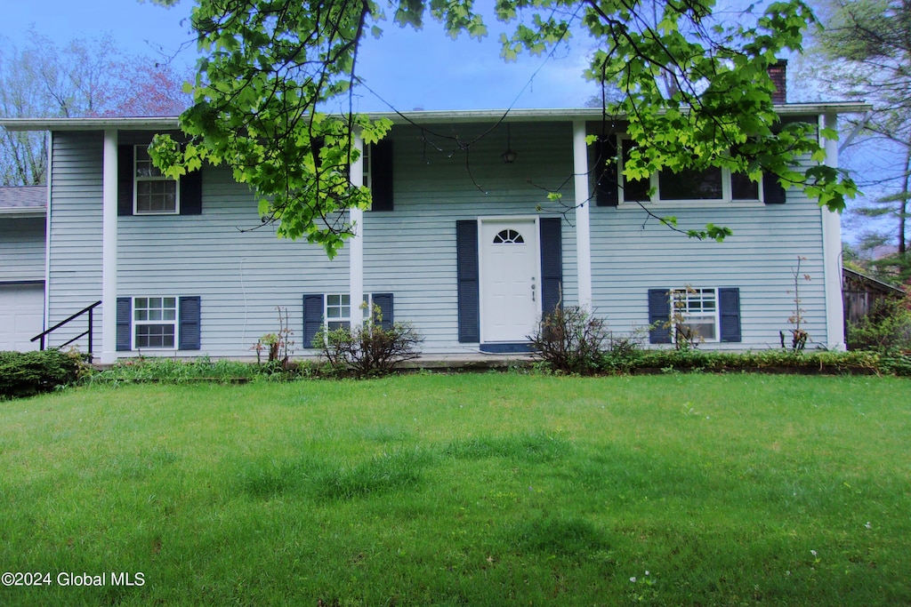 bi-level home with a front yard