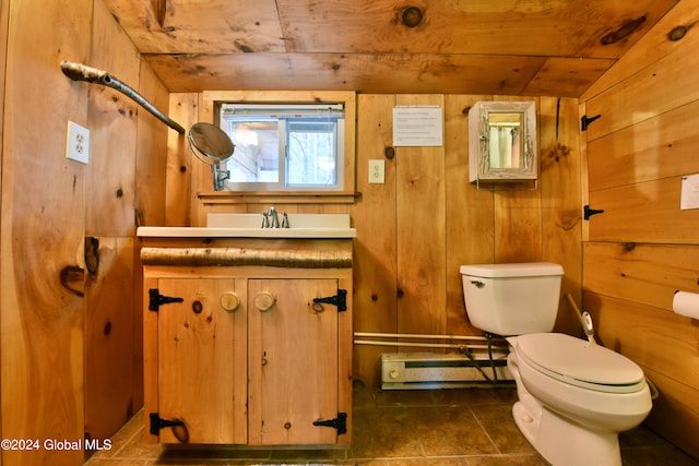 bathroom with wooden ceiling, toilet, wood walls, vanity, and tile patterned floors