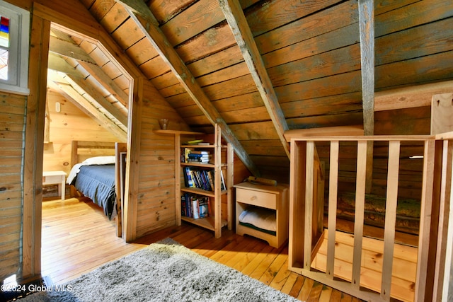 bedroom featuring light hardwood / wood-style flooring, lofted ceiling, and wood ceiling