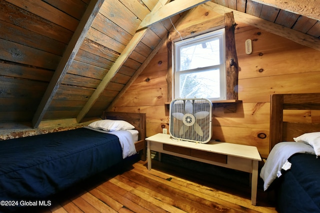 bedroom featuring wooden walls, vaulted ceiling with beams, light hardwood / wood-style floors, and wood ceiling