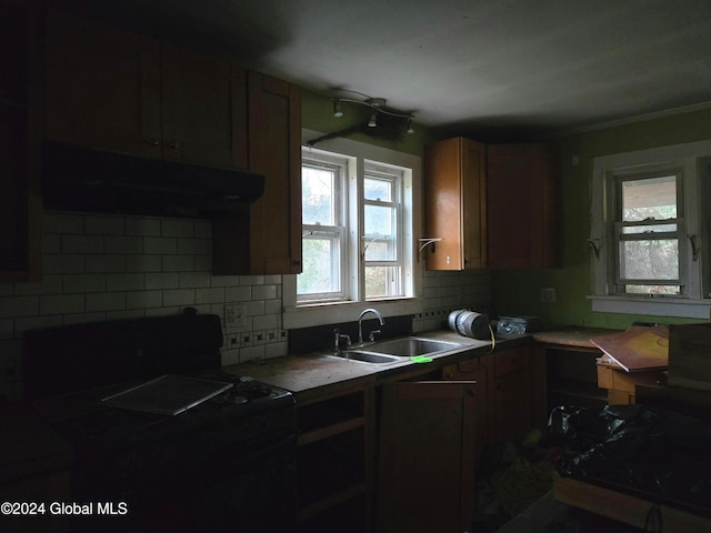 kitchen with sink, electric range, crown molding, and backsplash