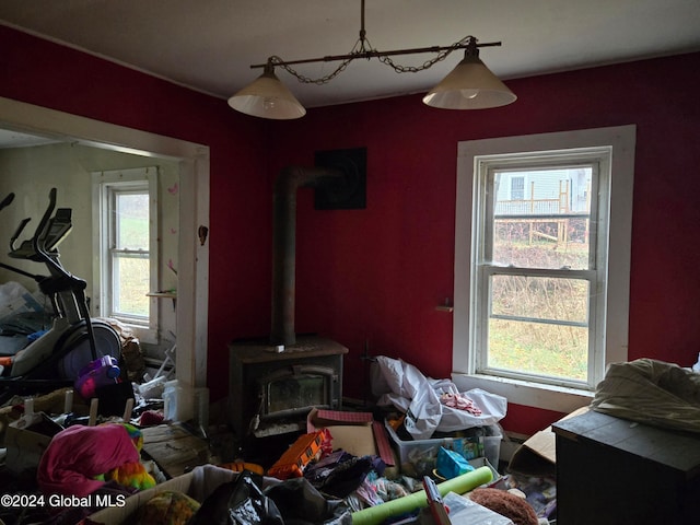 living room with a wood stove and a healthy amount of sunlight