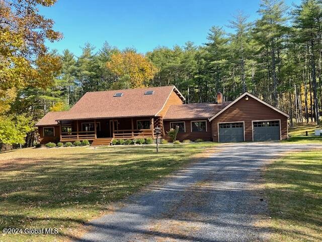 log-style house featuring a front lawn