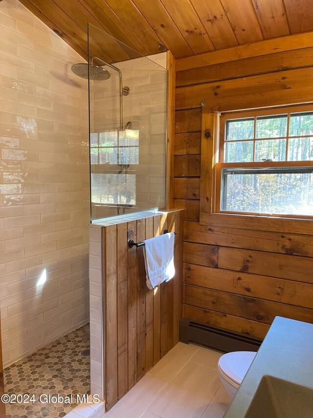 bathroom with wood ceiling, tile patterned floors, tiled shower, and toilet