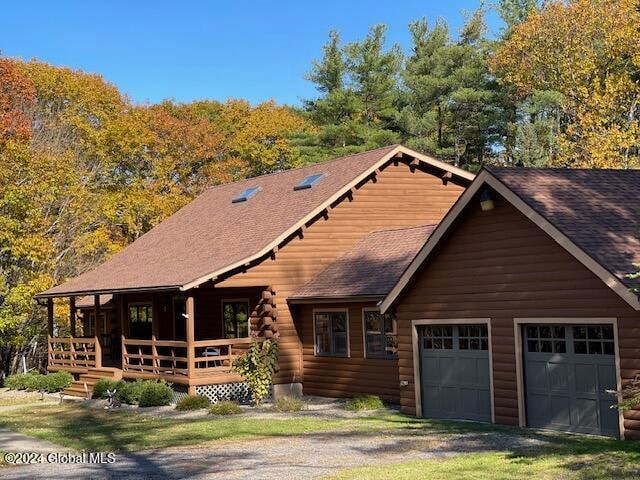 log cabin featuring a garage