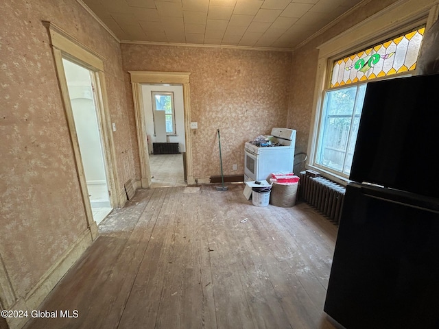 miscellaneous room featuring radiator heating unit, hardwood / wood-style flooring, and ornamental molding