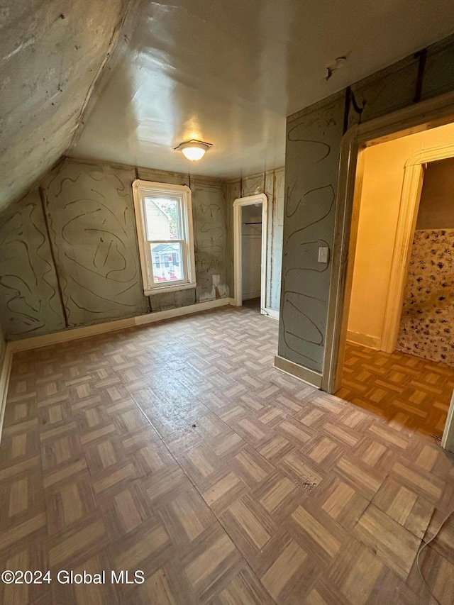 additional living space featuring lofted ceiling and parquet floors