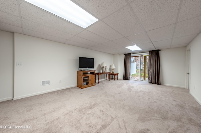 unfurnished living room with a drop ceiling and carpet floors