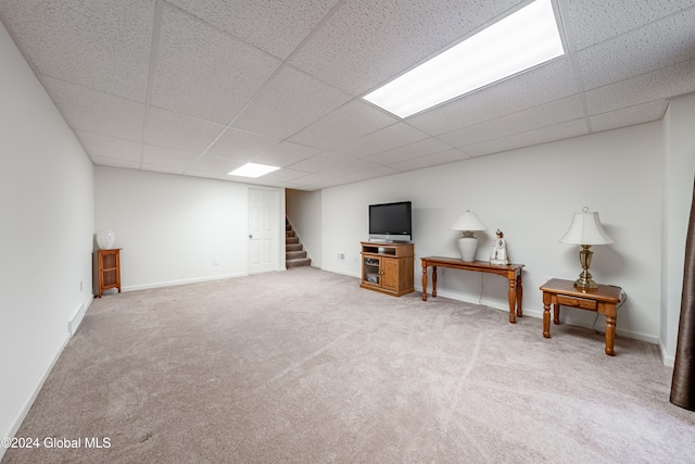 basement featuring a drop ceiling and carpet floors