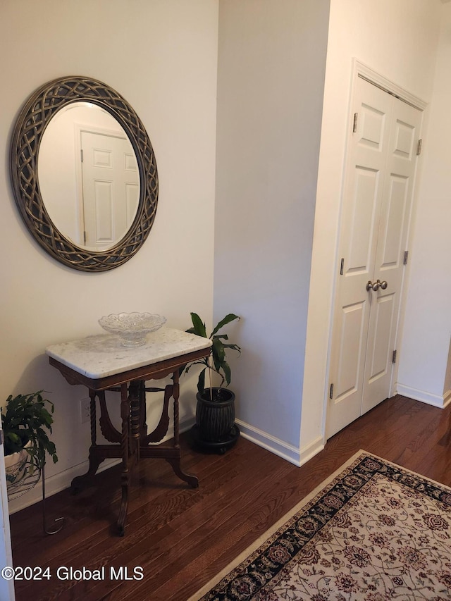 corridor with dark hardwood / wood-style flooring