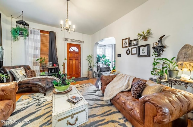 living room with a notable chandelier and hardwood / wood-style flooring