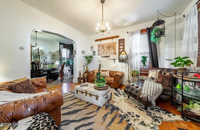 living room featuring hardwood / wood-style floors and an inviting chandelier