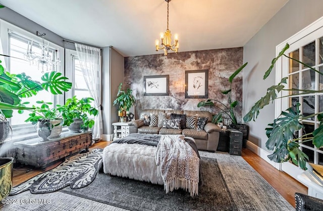 sitting room featuring a notable chandelier and hardwood / wood-style floors