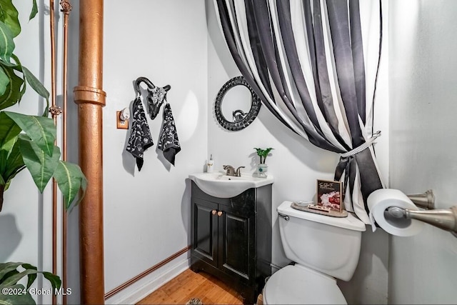 bathroom with vanity, hardwood / wood-style floors, and toilet