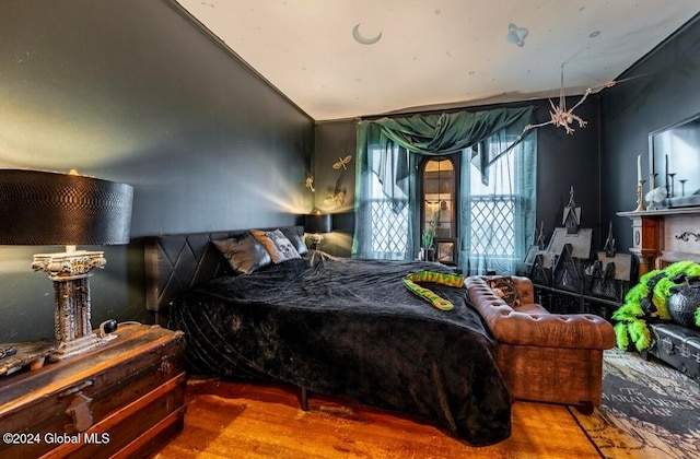 bedroom featuring hardwood / wood-style floors and vaulted ceiling