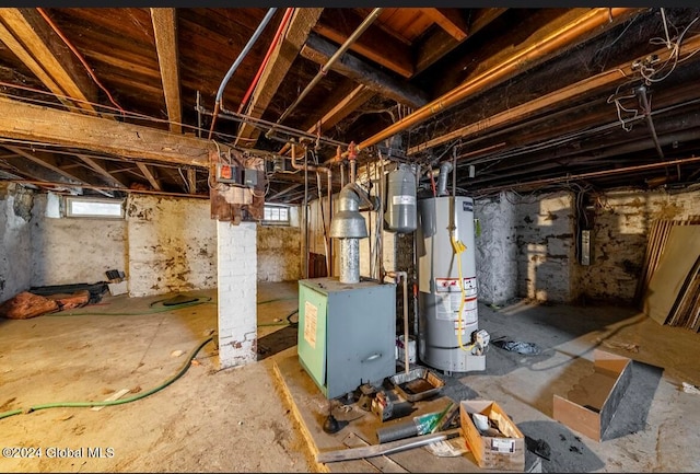 basement featuring a wealth of natural light and water heater