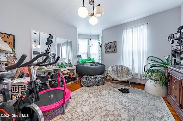 game room featuring a notable chandelier and hardwood / wood-style flooring