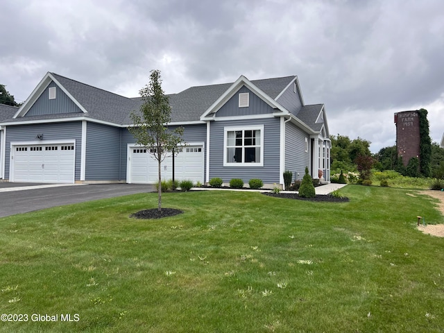 view of front of property with a front yard and a garage