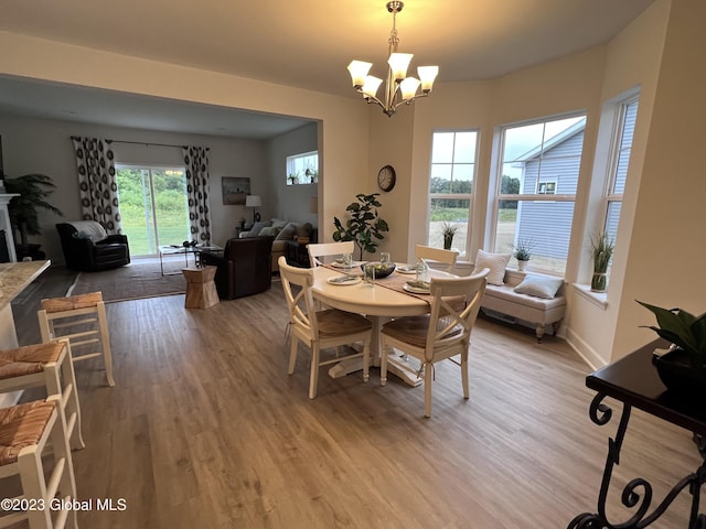 dining space with an inviting chandelier and light wood-style flooring