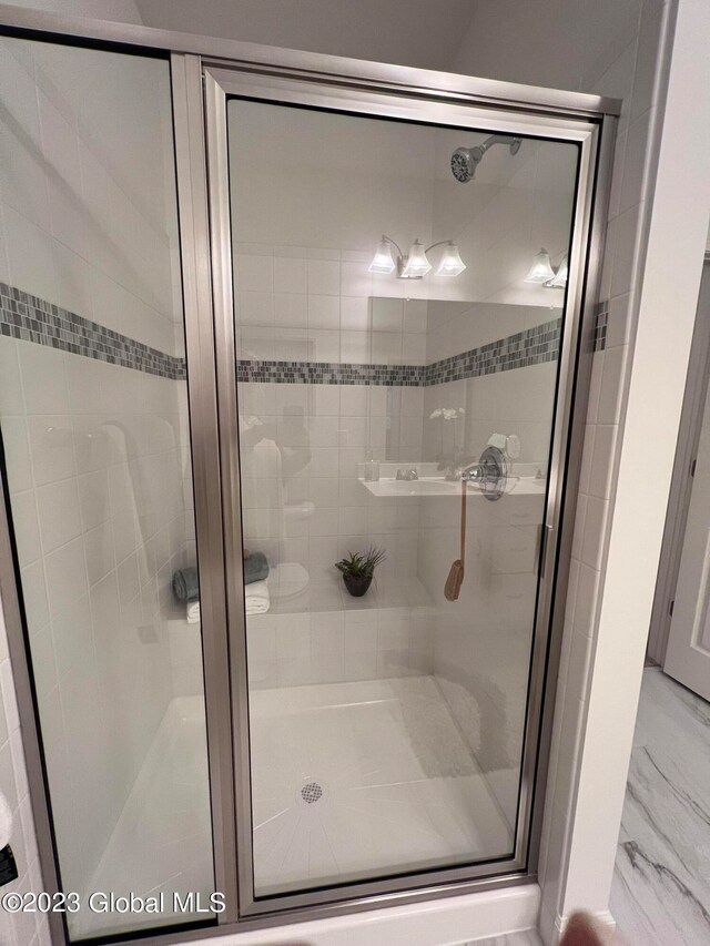 bathroom with a shower with shower door