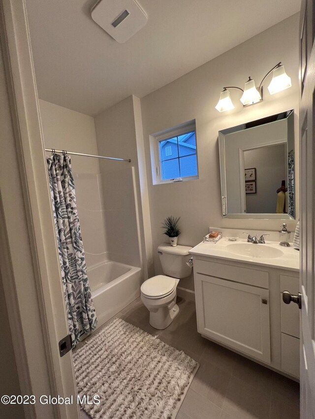 full bathroom with vanity, shower / bath combination with curtain, and toilet