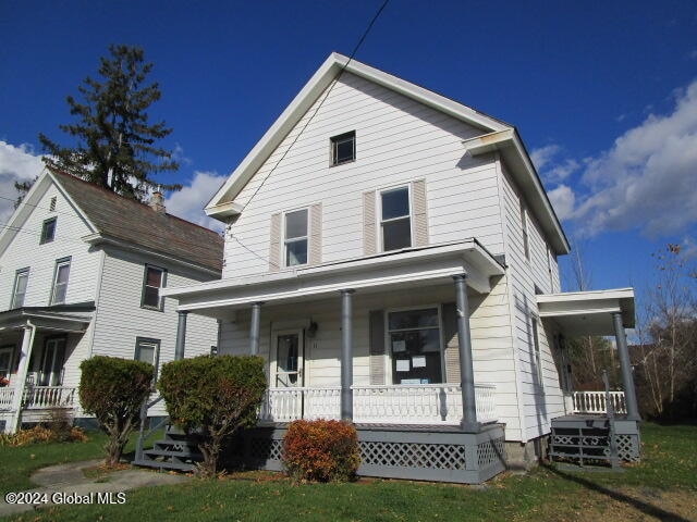 view of front of home with a front lawn and a porch