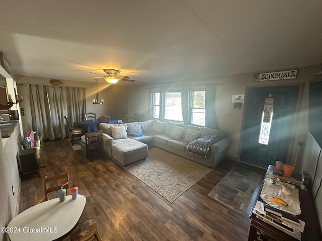 living room with dark hardwood / wood-style flooring and ceiling fan