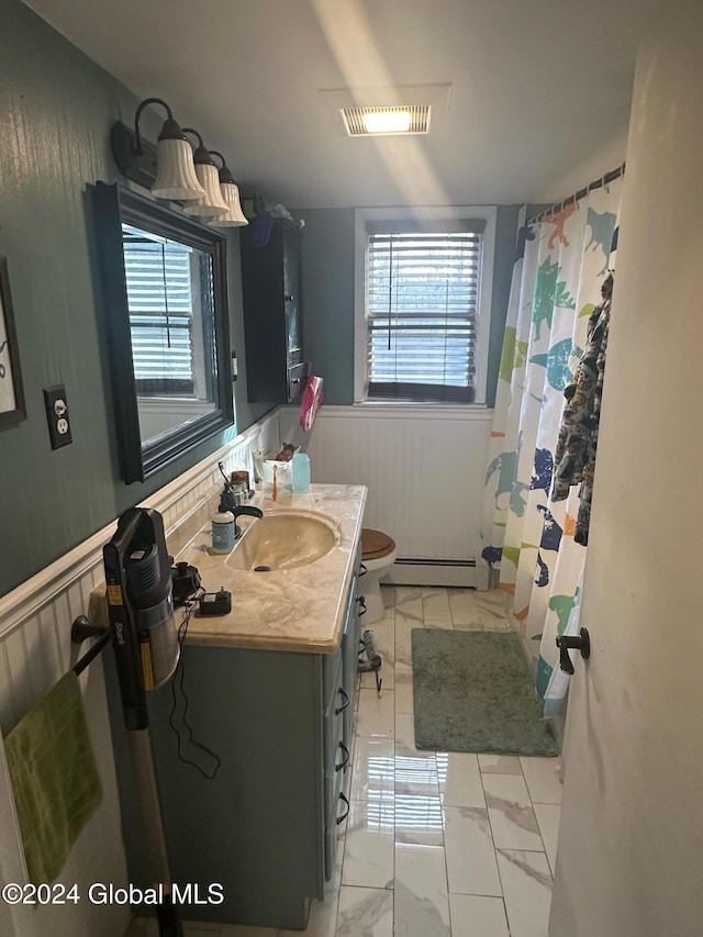 bathroom with a baseboard heating unit, vanity, and toilet