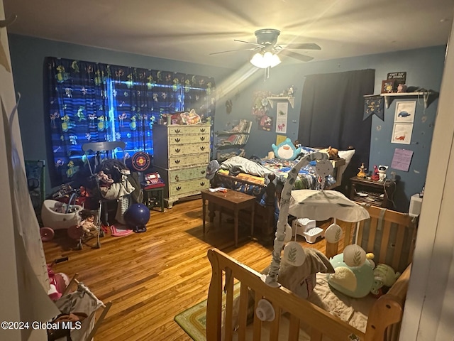 bedroom featuring hardwood / wood-style floors and ceiling fan