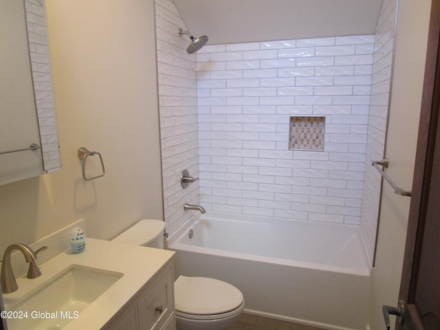 full bathroom with vanity, tiled shower / bath combo, and toilet