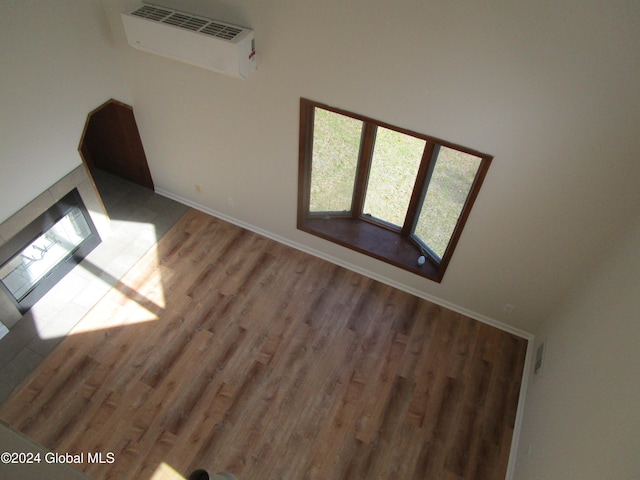 interior space featuring hardwood / wood-style floors and a wall unit AC