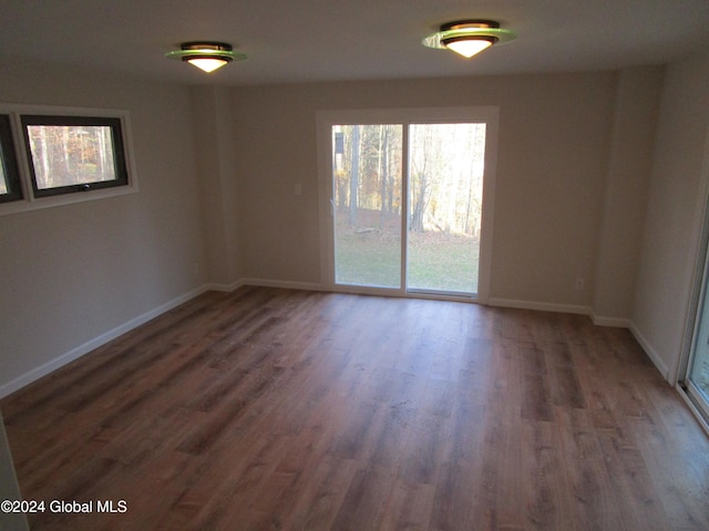 spare room with dark hardwood / wood-style floors