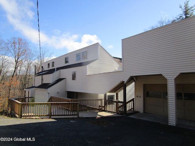 back of house featuring a deck