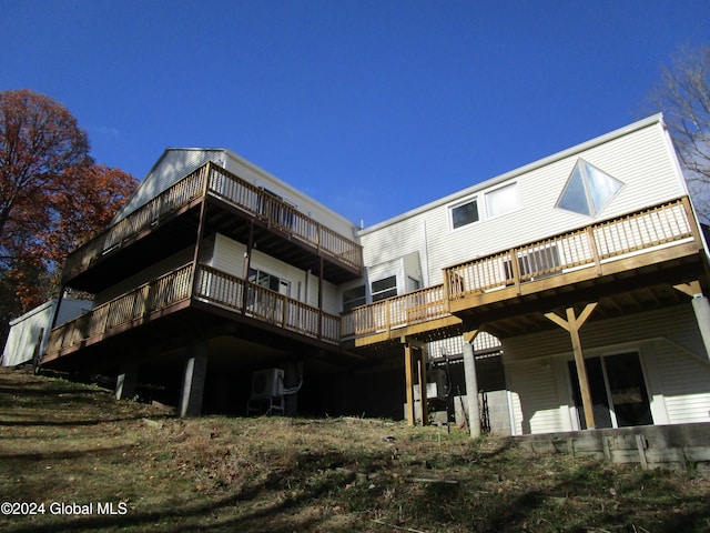 rear view of property with a wooden deck