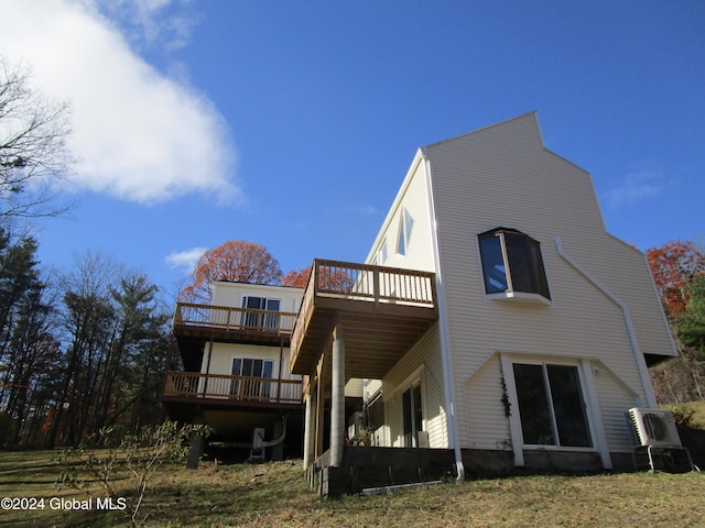 rear view of property featuring a wooden deck