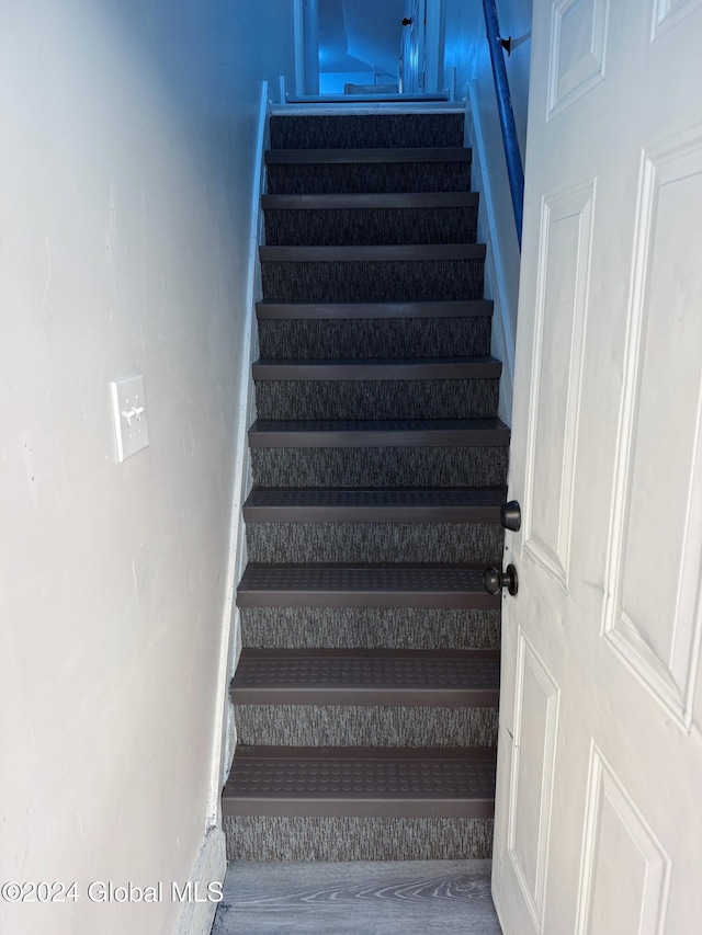 stairs featuring hardwood / wood-style flooring