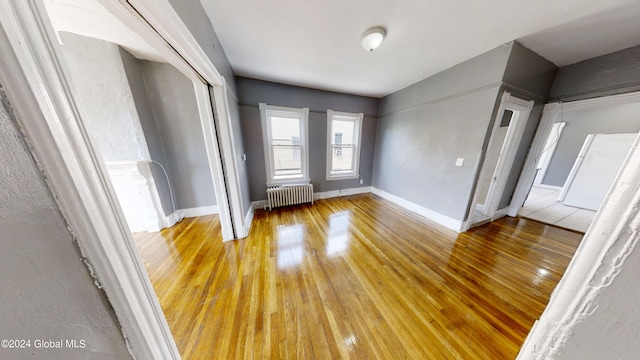 interior space with hardwood / wood-style flooring and radiator