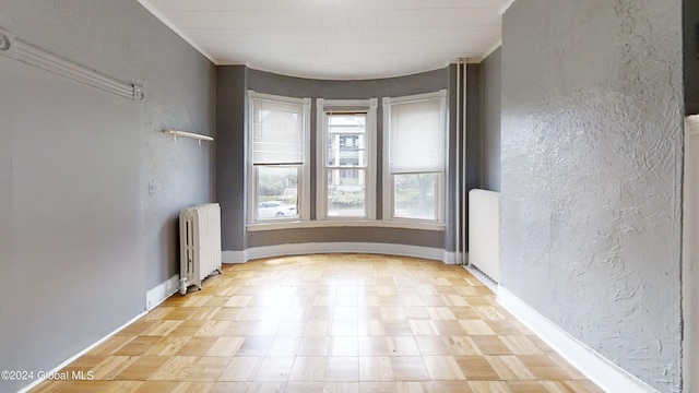 spare room featuring radiator heating unit