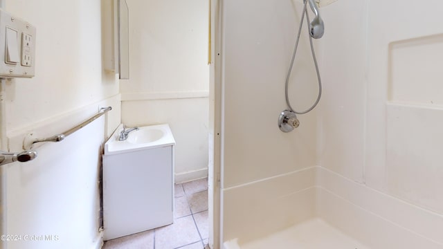 bathroom with vanity, tile patterned floors, and walk in shower