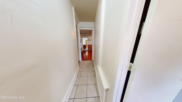 corridor with light tile patterned floors